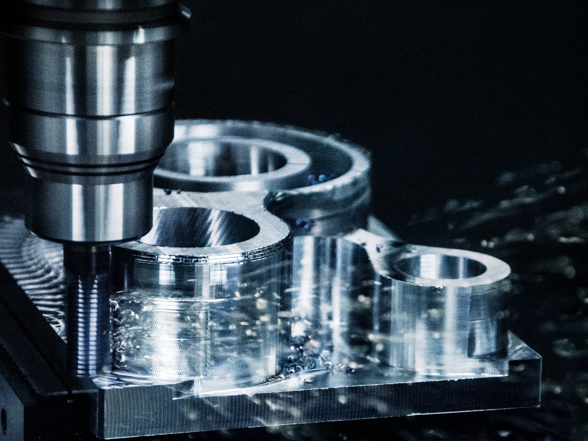 A lathe mid-cut on the RKC shop floor, with swarf and tooling visible